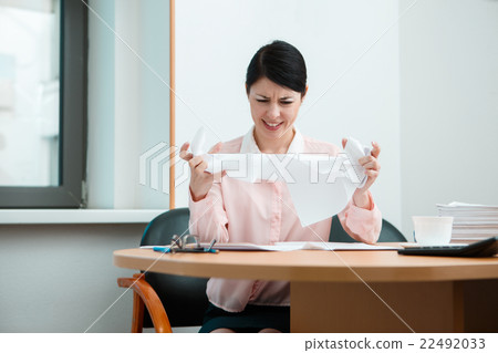 Woman in office with crumpled paper. 22492033