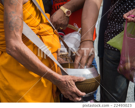 Buddhist monks are given food offering Buddhist monks are given food offering 22493023