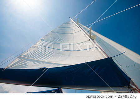 Sailing yacht in a smooth wind with sunny blue sky 22493276