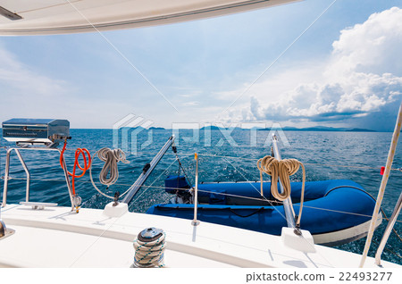 Rear of the luxury yacht with dingy and BBQ party Rear of the luxury yacht with dingy and BBQ party 22493277