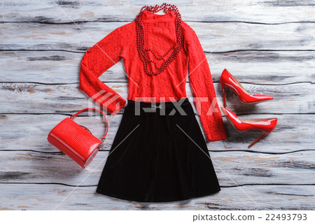Red top with black skirt. 22493793