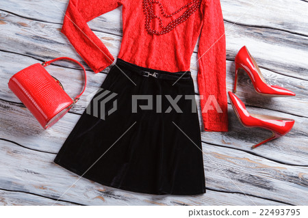 Black skirt and red bag. 22493795