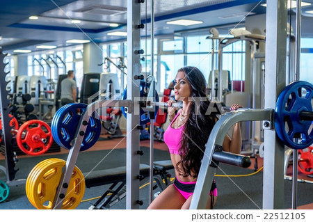 At gym. Pretty brunette training with barbell At gym. Pretty brunette training with barbell 22512105