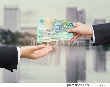 Hands of businessman passing Australian dollar. 22512226