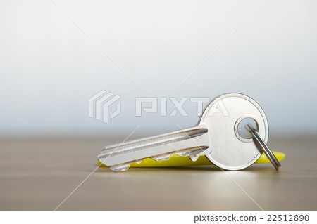 Silver key on wooden background. 22512890