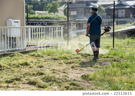 Men who mow the grass with a mowing machine 22513615