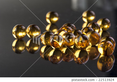 Omega capsules on black background 22513924
