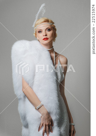 woman in white dress with shoulder straps and long fur stole woman in white dress with shoulder straps and long fur stole 22515974