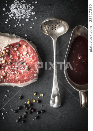 Marble ribeye steak, juniper, spoon, gravy boat Marble ribeye steak, juniper, spoon, gravy boat 22517280