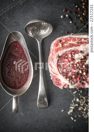 Marble ribeye steak, spoon, gravy boat, and salt Marble ribeye steak, spoon, gravy boat, and salt 22517281