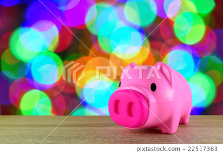 Pink piggy bank on wooden table 22517363