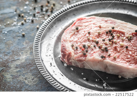 Piece of ribeye steak and peppercorn and salt  22517522