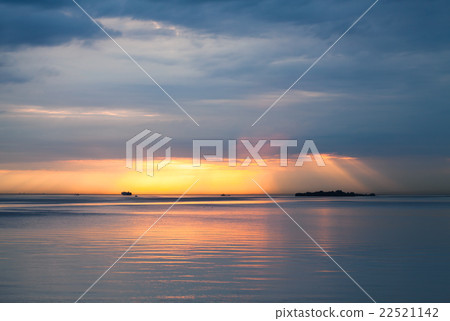 Sunset over Baltic Sea. Cloudy sky, still water 22521142