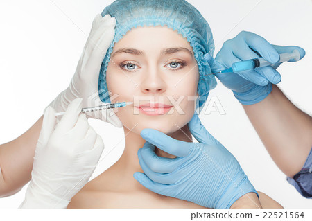 Attractive woman at plastic surgery with syringe Attractive woman at plastic surgery with syringe 22521564