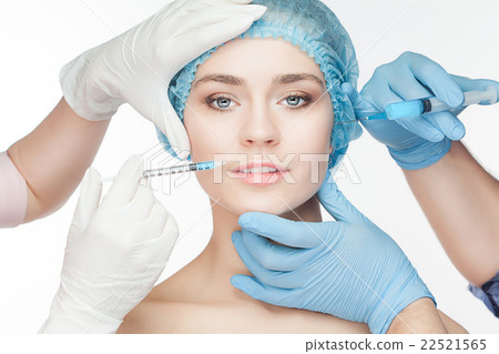 Attractive woman at plastic surgery with syringe Attractive woman at plastic surgery with syringe 22521565