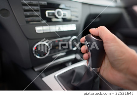 Driver shifting the gear stick 22521645