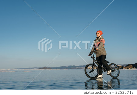 Girl on a bmx on ice. 22523712