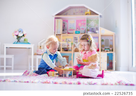 Kids playing with stuffed animals and doll house Kids playing with stuffed animals and doll house 22526735