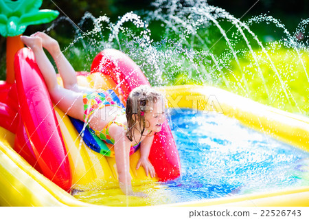 Little girl playing in inflatable garden swimming pool Little girl playing in inflatable garden swimming pool 22526743
