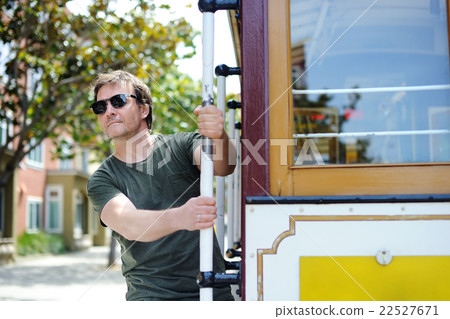 Male tourist taking a ride in famous cable car in San Francisco 22527671