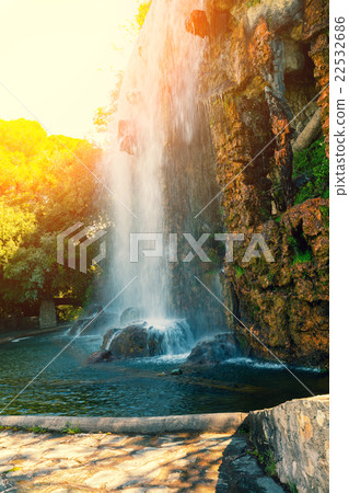 Waterfall in the park at sunrise 22532686