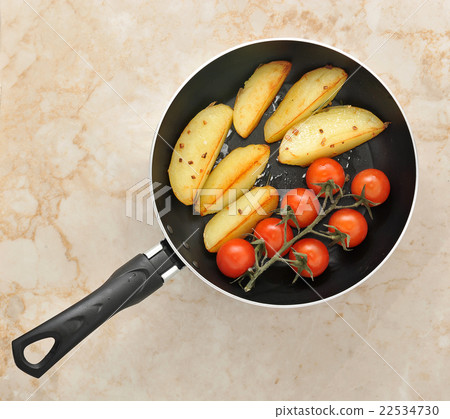 fried potatoes and cherry tomatoes 22534730