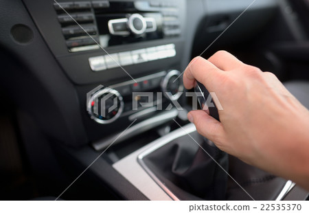 Driver shifting the gear stick 22535370