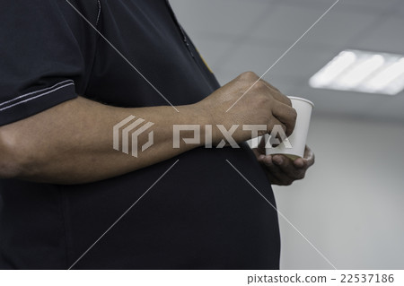 big paunch man hold a cup of coffee big paunch man hold a cup of coffee 22537186