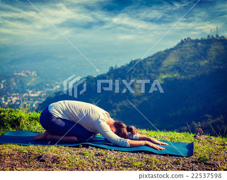 Sporty fit woman practices yoga asana Balasana Sporty fit woman practices yoga asana Balasana 22537598