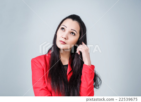 Young thoughtful woman in red jacket 22539675