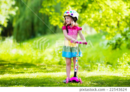 Little girl riding a colorful scooter 22543624