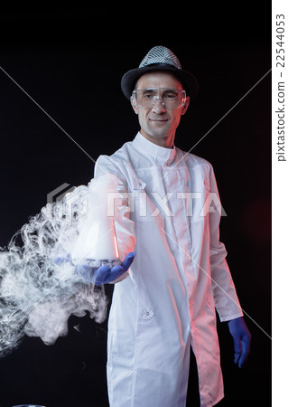 Smiling man scientist with dry ice Smiling man scientist with dry ice 22544053