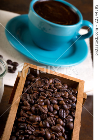 Cup of coffee, containers filled with cofee beans Cup of coffee, containers filled with cofee beans 22544595