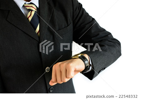 Businessman checking the time on his wrist watch Businessman checking the time on his wrist watch 22548332