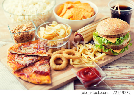 close up of fast food snacks and drink on table close up of fast food snacks and drink on table 22549772