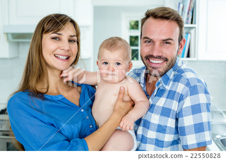 Happy parents with baby boy at home 22550828