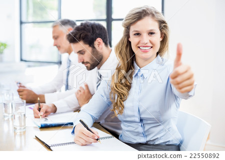 Portrait of businesswoman showing thumbs up 22550892
