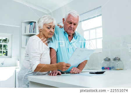 Senior couple calculating finances at home Senior couple calculating finances at home 22551074