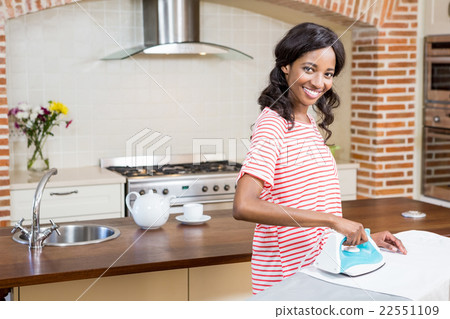 Young woman ironing her clothes Young woman ironing her clothes 22551109