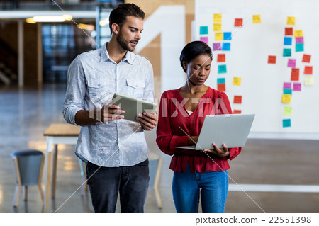 Colleagues interact using digital tablet 22551398