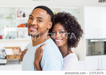 Young couple embracing in kitchen 22552074