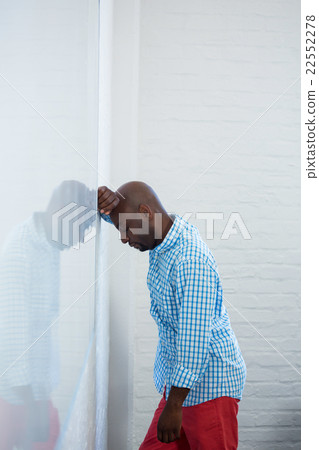 Upset man with eyes closed and hand on the forehead leaning agai Upset man with eyes closed and hand on the forehead leaning agai 22552278