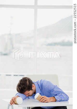 Businessman relaxing on desk Businessman relaxing on desk 22552515