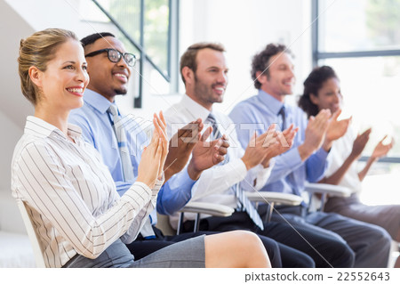 Businesspeople applauding while in a meeting 22552643
