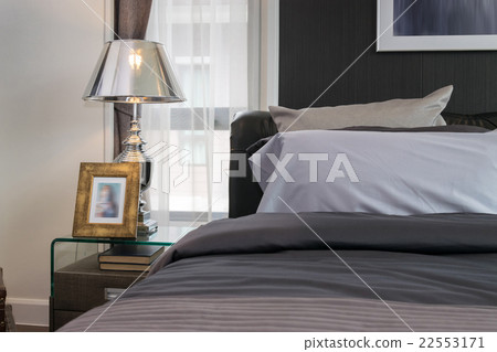 luxury lamp and picture frame on bedside table 22553171