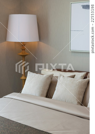 classic bedroom with wooden lamp and pillows classic bedroom with wooden lamp and pillows 22553198
