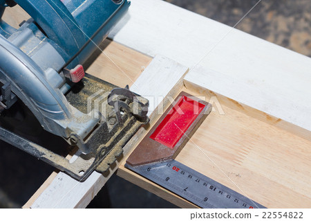 circular saw cutting wood and iron ruler circular saw cutting wood and iron ruler 22554822