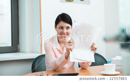 Woman in office with crumpled paper. Woman in office with crumpled paper. 22557863