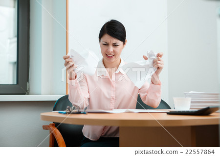 Woman in office with crumpled paper. Woman in office with crumpled paper. 22557864