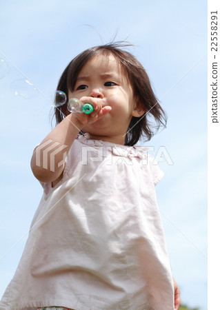 Infant playing with soap bubble (1 year old child) Infant playing with soap bubble (1 year old child) 22558291